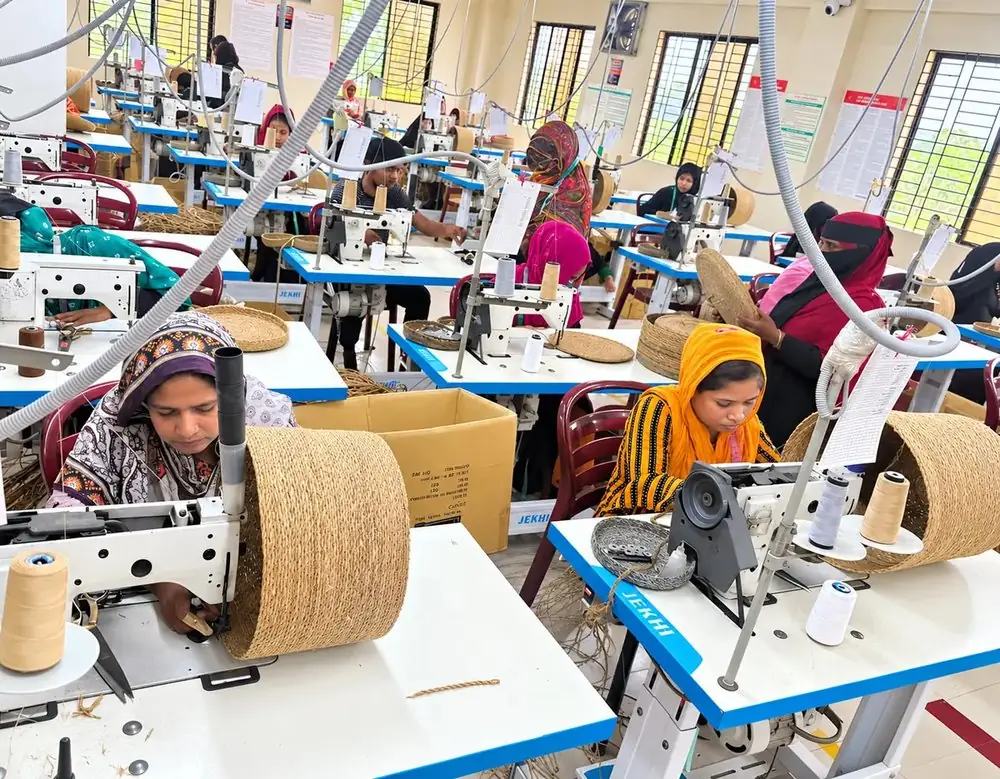 RES Eco-Craft artisans hand-weaving seagrass baskets on the factory floor